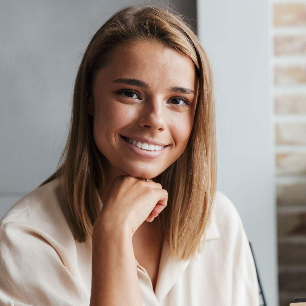 image of young smiling woman reading book while si cfxp539.jpg